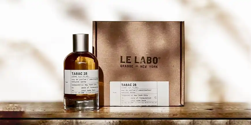 Eco-friendly kraft mailer box for perfume with custom sticker and minimalist branding